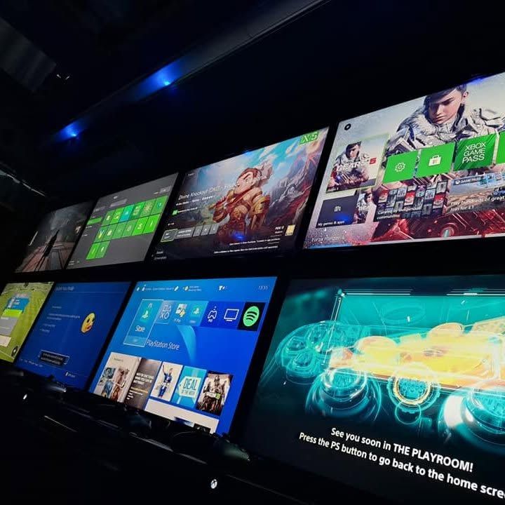 Row of gaming screens inside the Game Bus